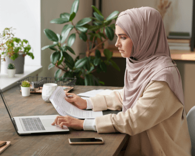 A compliance officer checks an SEC filing while Arabic Translation Services in New York translate finance disclosures.