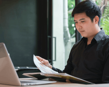 An editor proofreads a certified Chinese translation for legal compliance, using Chinese Translation Services in New York.