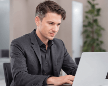 A translator works on a laptop with tracked changes during Translation Services in Brooklyn for business document.