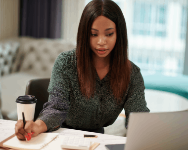 A client signs tax forms prepared with Haitian Creole Translation Services in New York for financial communications.