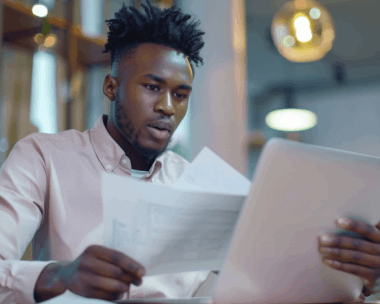 A client checks a certified personal letter from Haitian Creole Translation Services in New York at a kitchen table.