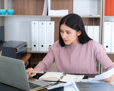 A client reviews personal forms with a linguist, using Translation Services in Flushing for individual help.