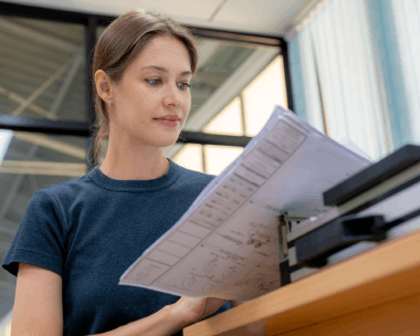 A client reviews USCIS forms with Russian Translation Services in New York, matching Russian documents to English fields.