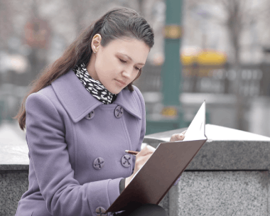 A client hands personal documents for Russian Translation Services in New York while a translator confirms official.