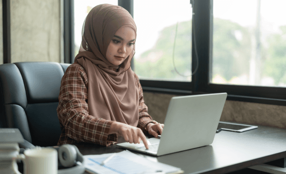A certified linguist checks an Arabic contract at a NYC desk, providing Arabic Translation Services in New York on deadline.