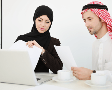 Two linguists review an Arabic ID translation for a visa file as Arabic Translation Services in NY check personal details.