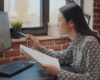 A linguist compares a Korean user guide to schematics as Korean Translation Services in New York ensure technical accuracy.