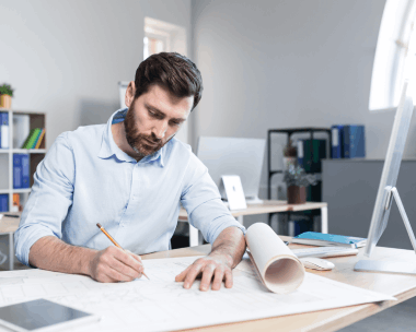 Engineer reviews CAD drawings using Translation Services in Manhattan, ensuring accurate IT and engineering terminology.