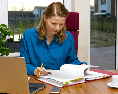A translator edits an academic thesis at a desk, using Translation Services in Manhattan to preserve technical meaning.