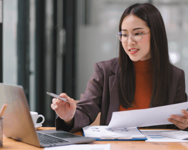 Translator compares Spanish and English clauses on a laptop, using Translation Services in Flushing for legal precision.